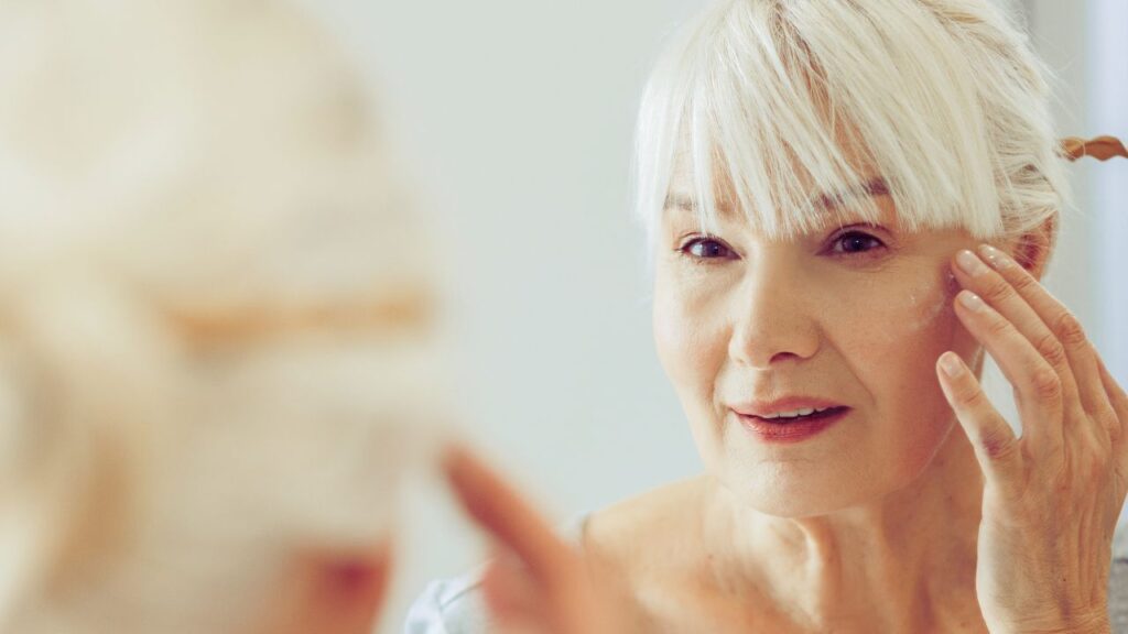 a women looking at her skin for menopause symptoms 